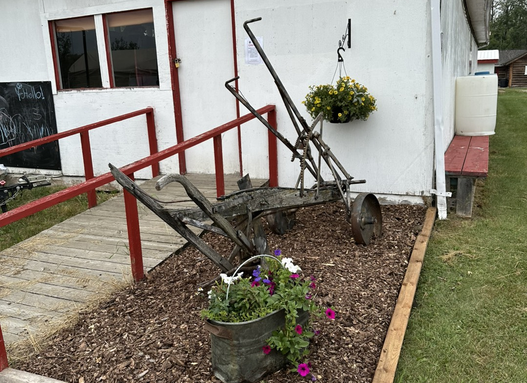 Flowers and farming equipment at the North Peace Regional Park